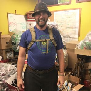 Smiling man in blue shirt and hat